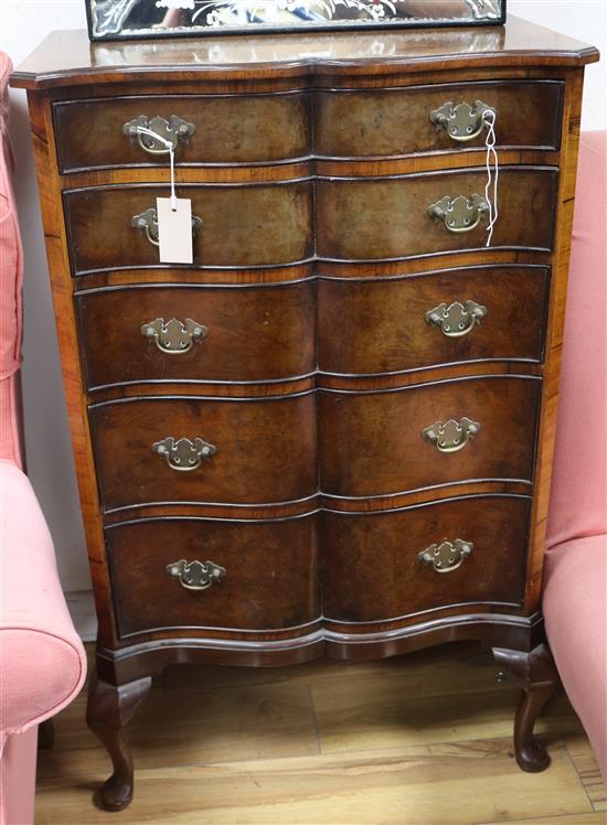 A walnut five-drawer chest, of serpentine form W.61cm